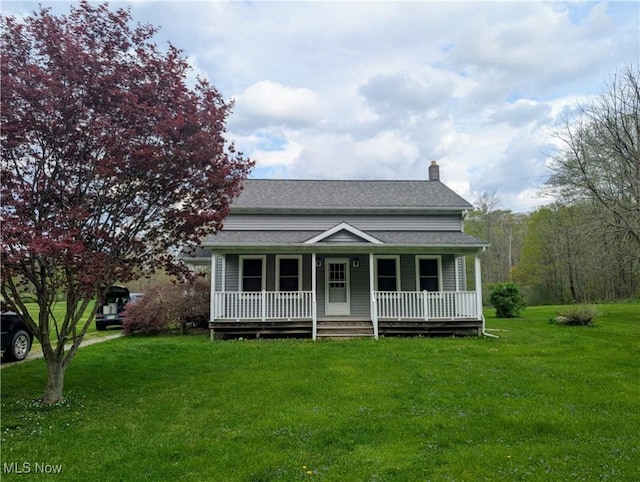 bungalow-style house featuring roof with shingles, a chimney, a porch, and a front yard