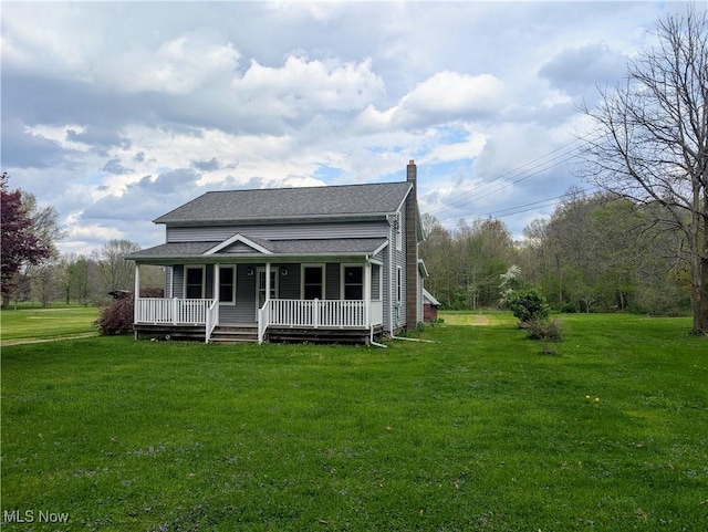 view of front of home featuring a shingled roof, a chimney, a porch, and a front lawn