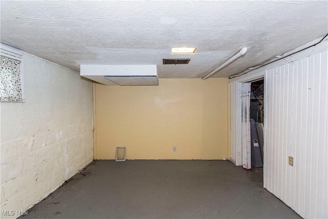 finished below grade area with visible vents and concrete block wall