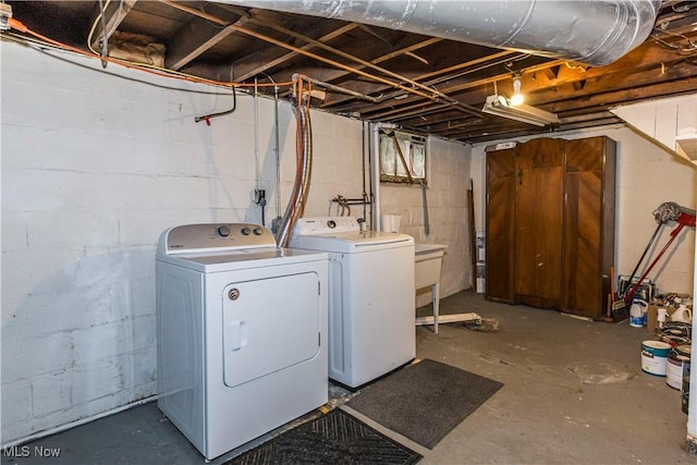 clothes washing area with independent washer and dryer and laundry area