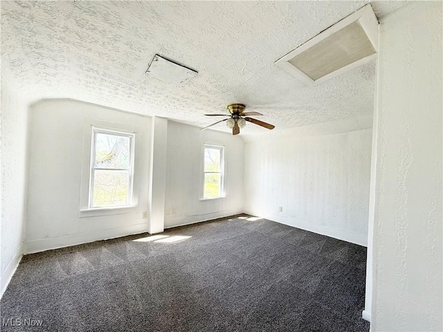 spare room with a textured ceiling and carpet