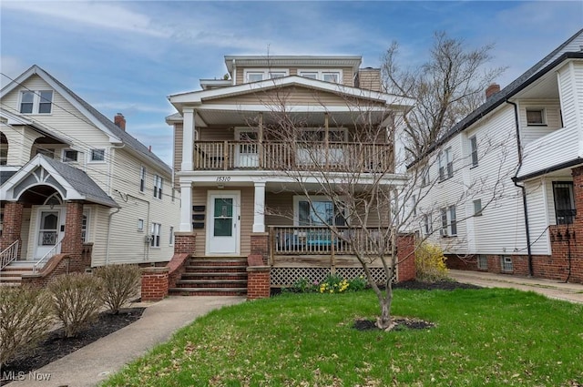 view of front of house featuring a porch, a front lawn, and a balcony