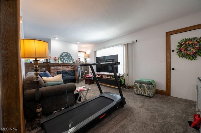workout area with carpet floors and a brick fireplace