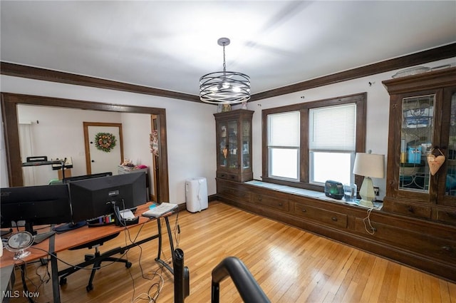 home office featuring light wood-type flooring and ornamental molding
