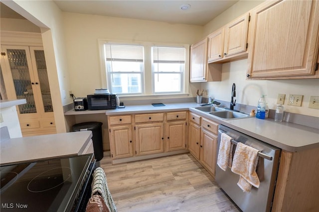 kitchen featuring french doors, a sink, light countertops, black appliances, and light brown cabinets