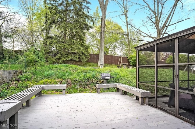 wooden terrace with fence and a sunroom