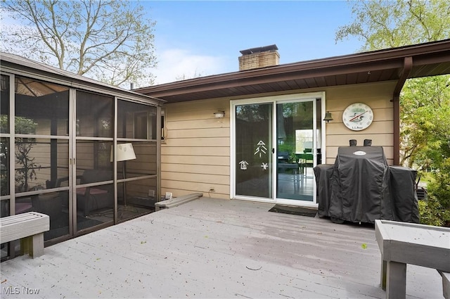 wooden deck featuring a sunroom