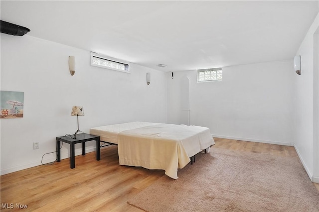 bedroom with baseboards and light wood-type flooring
