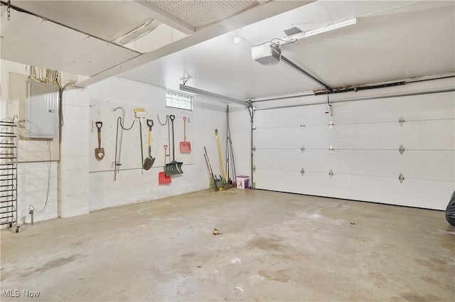 garage with a garage door opener and electric panel