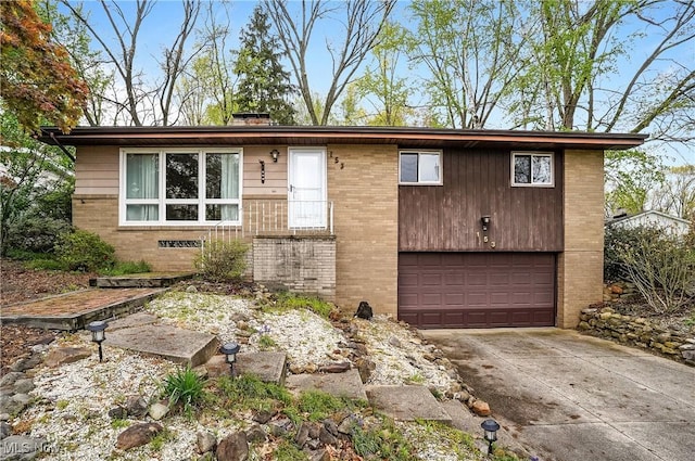 view of front of property with brick siding, a garage, and driveway