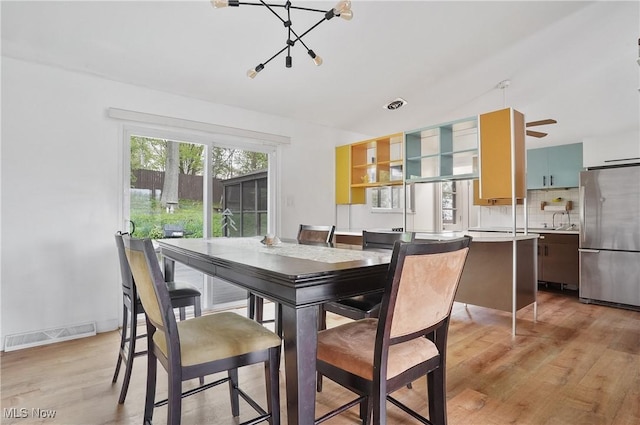 dining space with visible vents and light wood-style flooring
