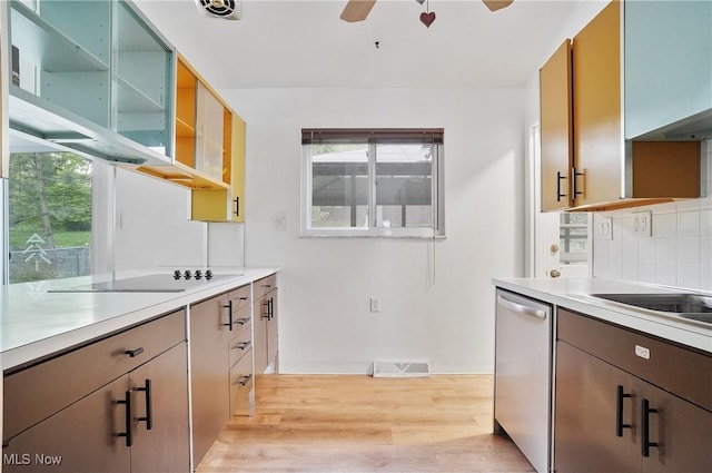 kitchen with ceiling fan, light wood finished floors, black electric cooktop, stainless steel dishwasher, and visible vents