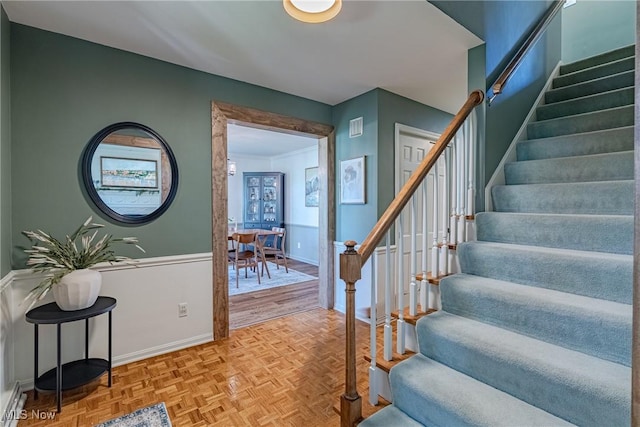 stairway with baseboards and visible vents