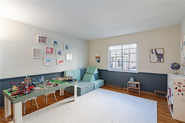 playroom featuring wood finished floors and visible vents