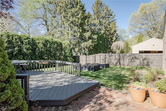wooden terrace with a fenced backyard and a yard