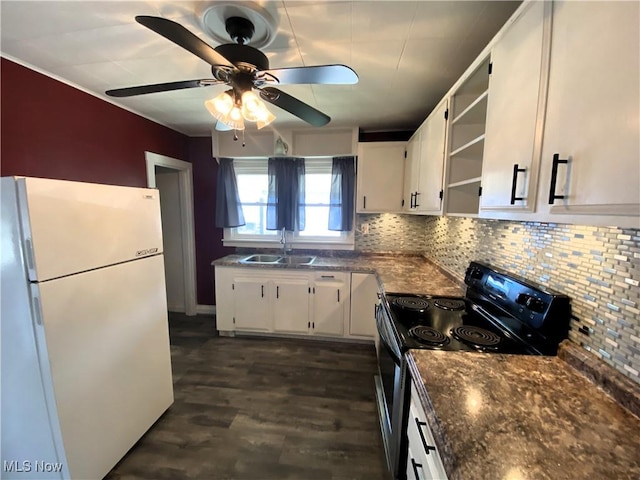 kitchen with freestanding refrigerator, electric range, open shelves, white cabinetry, and a sink