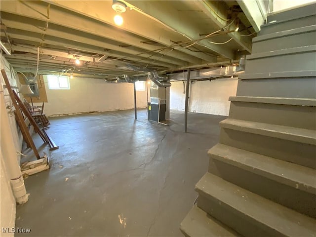 below grade area with heating unit and stairway