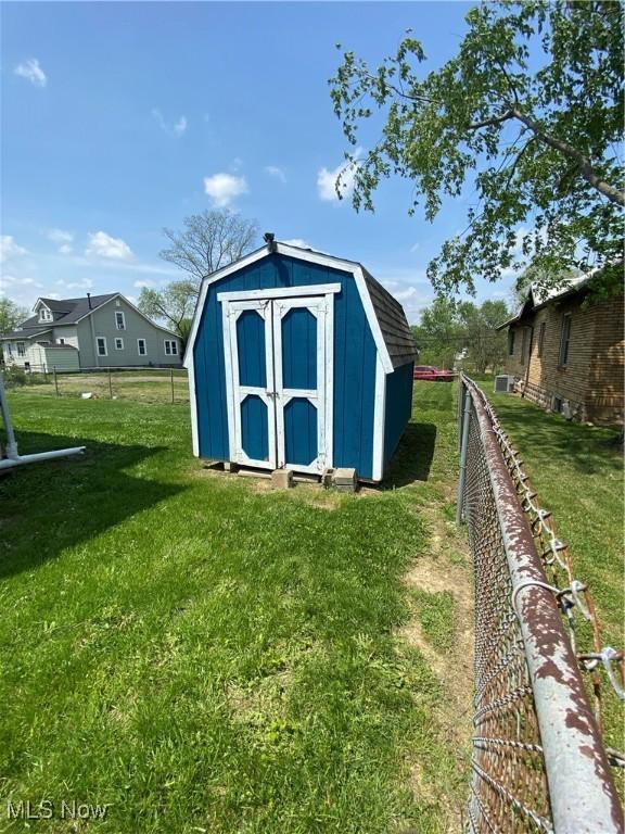 view of shed featuring fence