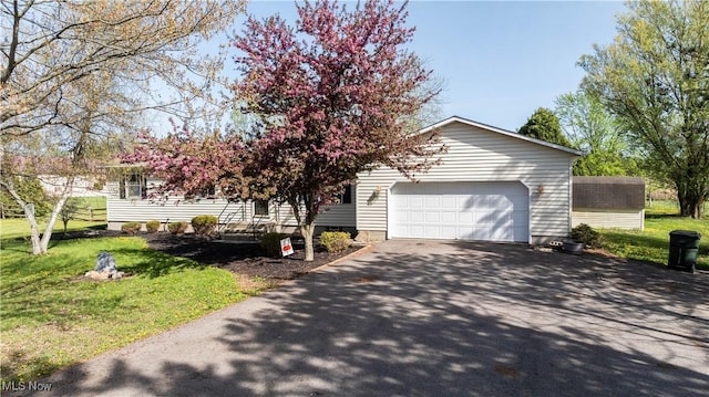 view of front facade featuring a garage, driveway, and a front yard