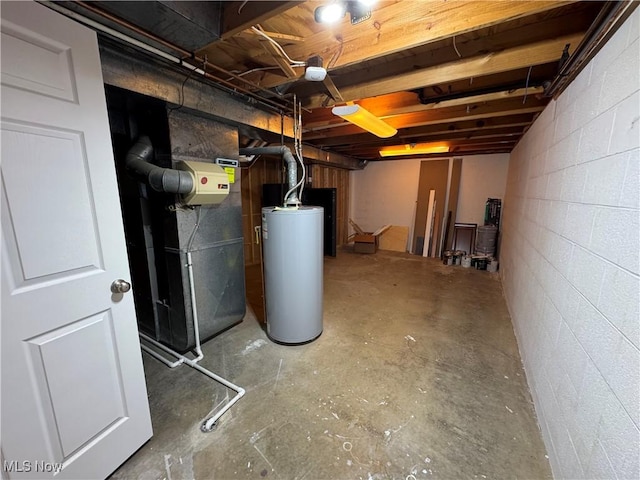 unfinished basement featuring heating unit, concrete block wall, and gas water heater