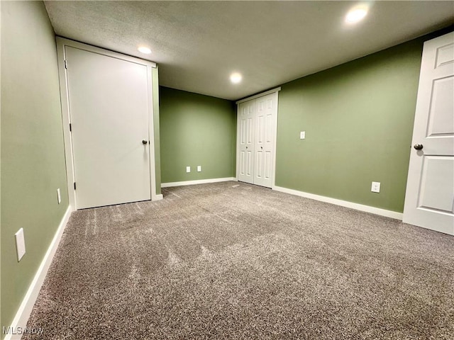 unfurnished bedroom featuring recessed lighting, baseboards, and carpet