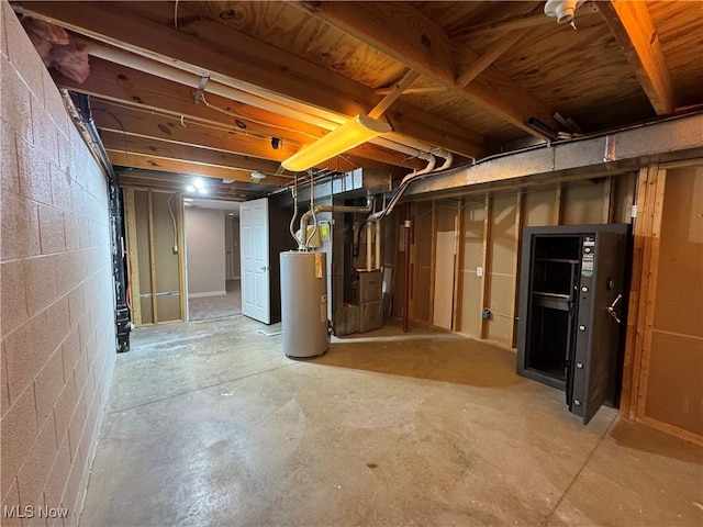 unfinished basement with heating unit, water heater, and concrete block wall