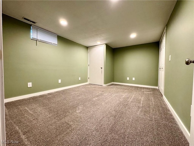finished below grade area featuring visible vents, recessed lighting, carpet, and baseboards