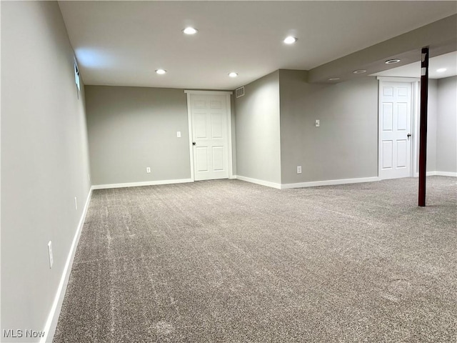 finished basement with carpet floors, baseboards, recessed lighting, and visible vents