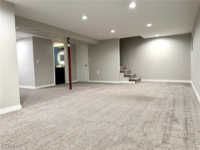 finished basement featuring stairway, baseboards, carpet flooring, and recessed lighting