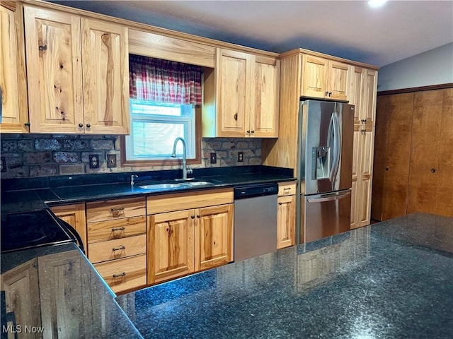 kitchen with a sink, light brown cabinetry, tasteful backsplash, and stainless steel appliances