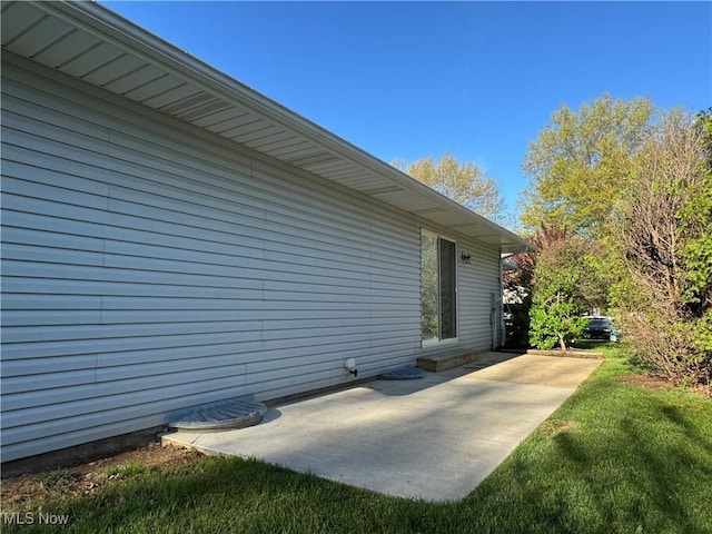 view of side of home featuring a patio area
