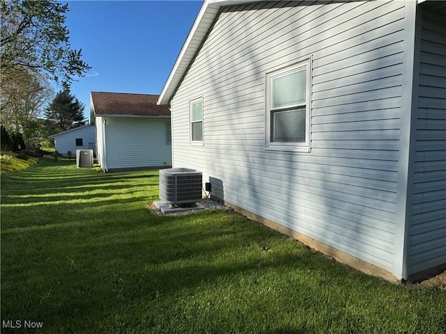 view of home's exterior featuring a lawn and cooling unit