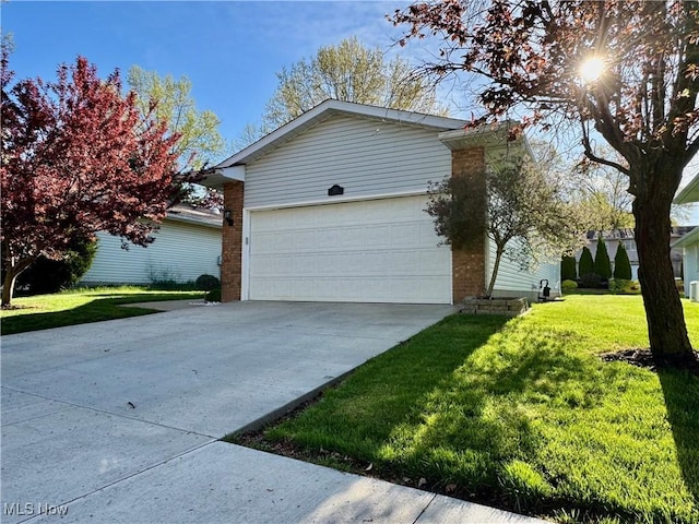 view of home's exterior with a lawn, brick siding, concrete driveway, and a garage
