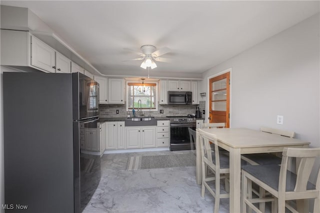 kitchen with decorative backsplash, ceiling fan, appliances with stainless steel finishes, a sink, and white cabinetry