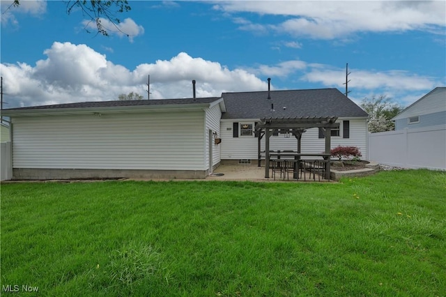 rear view of house featuring fence, a pergola, a yard, and a patio area
