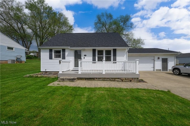 view of front of home featuring a front lawn, covered porch, central AC unit, concrete driveway, and an outbuilding