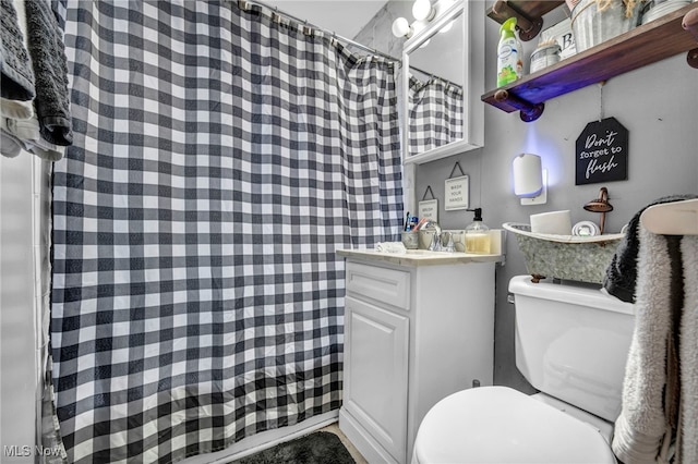 bathroom with vanity, a shower with curtain, and toilet