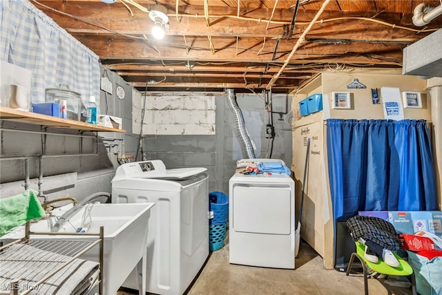 washroom featuring laundry area and washing machine and clothes dryer