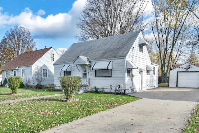 view of front of house with roof with shingles, a detached garage, a front yard, an outdoor structure, and driveway