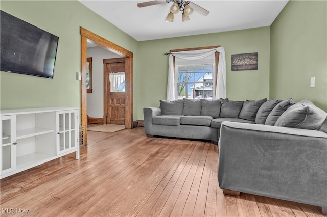 living room featuring a ceiling fan and hardwood / wood-style floors