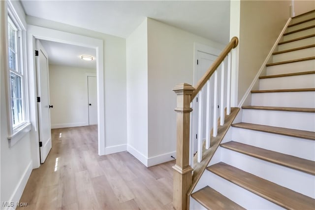 stairs with baseboards and wood finished floors