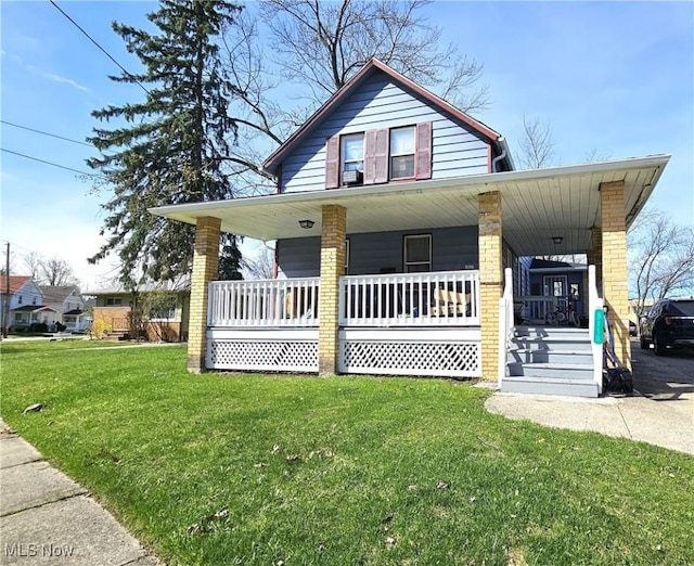 view of front of house featuring a porch, brick siding, and a front yard