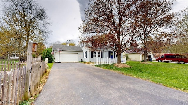 view of front of house with a garage, aphalt driveway, fence, and a front yard
