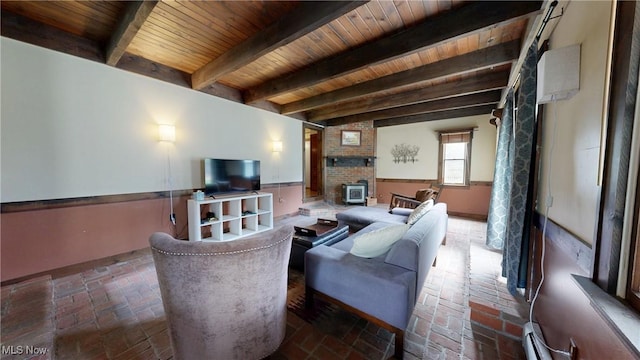 living room with baseboard heating, beam ceiling, brick floor, baseboards, and wood ceiling