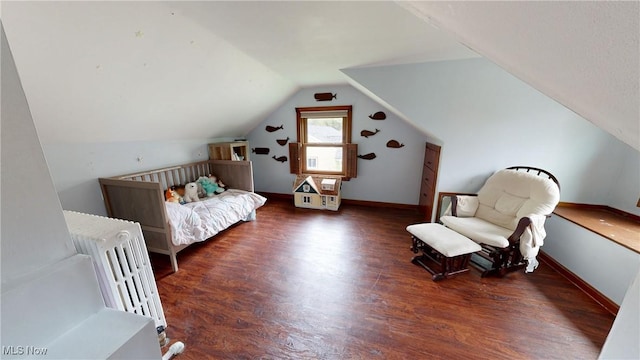 bedroom with baseboards, wood finished floors, and lofted ceiling