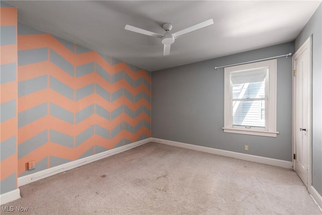 empty room featuring baseboards, carpet, and ceiling fan