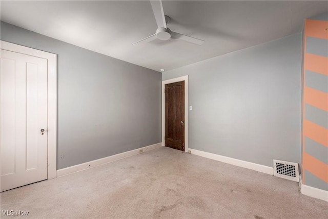 unfurnished bedroom with carpet floors, baseboards, visible vents, and ceiling fan