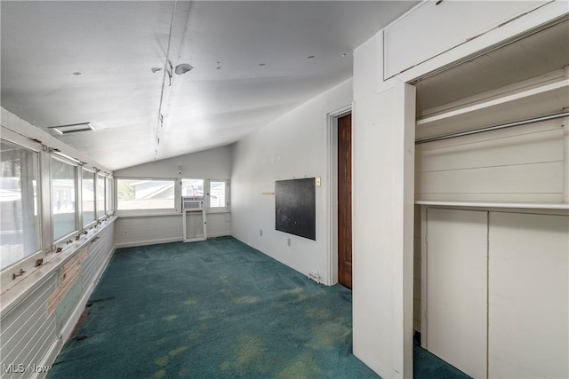 hallway featuring carpet flooring and vaulted ceiling