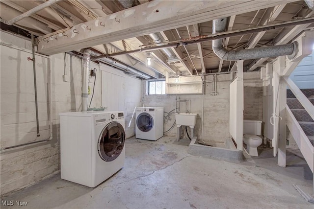basement featuring a sink and washer and clothes dryer