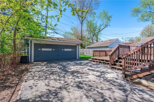 detached garage featuring fence